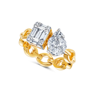 A yellow gold chain ring that features an illusion emerald cut diamond and an illusion pear diamond. 