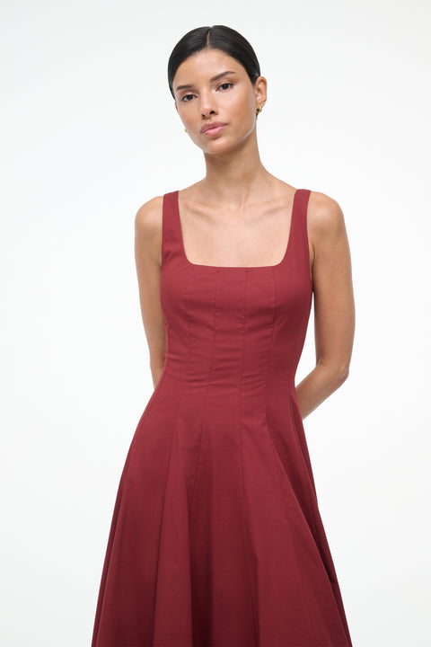 Woman wearing a red dress against a white background