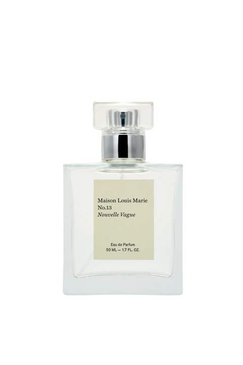 Square clear perfume bottle with a silver lid an beige square label. 