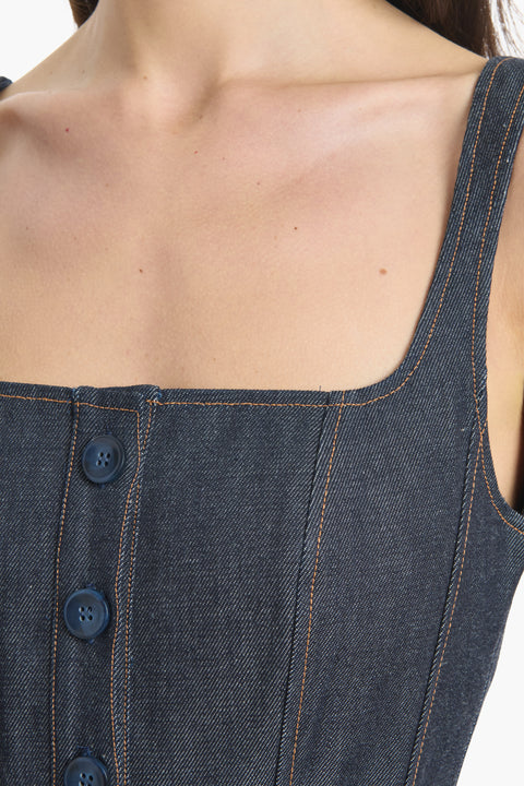Close-up of a blue denim dress with buttons and square neckline on a white background