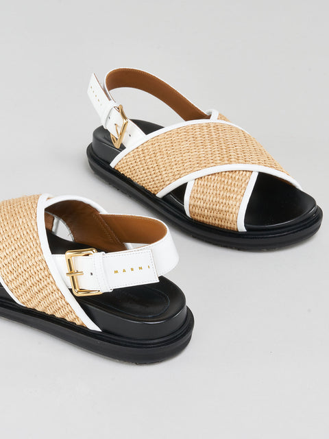 Up close image of the fussbett sandals with raffia effect fabric and white and black leather.