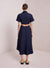 Model facing the back in the navy blue midi dress with an open back cutout