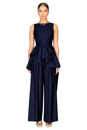 Model styled in the wide leg side panel trousers in navy with white pinstripes.