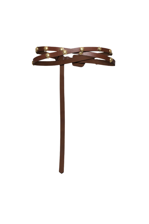 A brown leather belt with gold studs on a white background. 