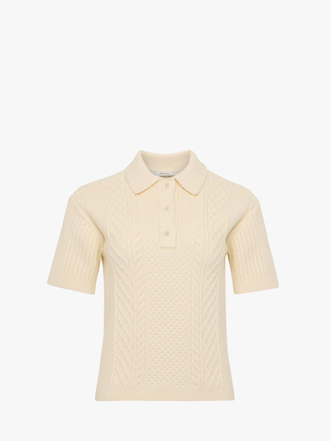 Cream-colored knitted polo shirt on a white background
