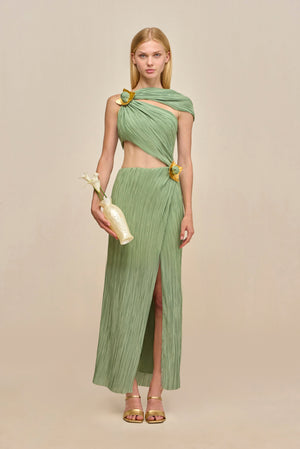 Woman wearing a green maxi dress crafted from plisse fabric that features a torso cutout and an asymmetric off-the-shoulder strap and gold-toned hardware details. 