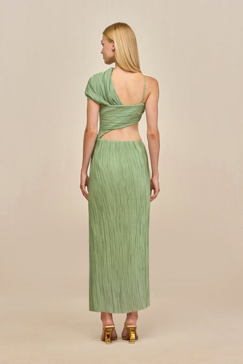 Back-facing woman wearing a green maxi dress crafted from plisse fabric that features a torso cutout and an asymmetric off-the-shoulder strap and gold-toned hardware details. 
