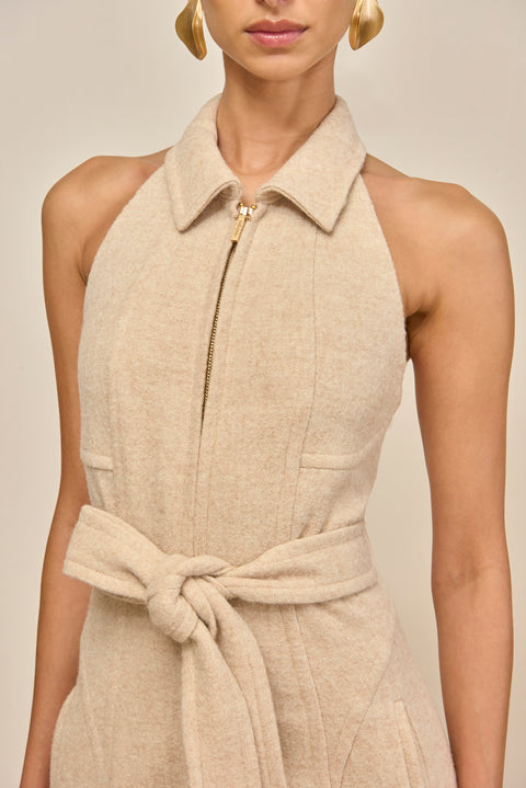 Beige sleeveless dress with a belt on a neutral background