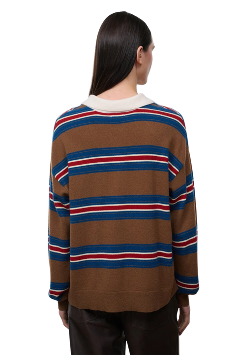 A model shown from the back wearing a brown knit sweater with horizontal blue and red stripes and a cream ribbed collar, paired with dark brown pants against a white background.