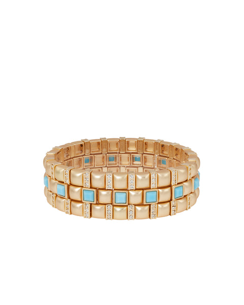 A set of three gold-tone stretch bracelets that feature square beads with alternating pave beads and turquoise beads. 