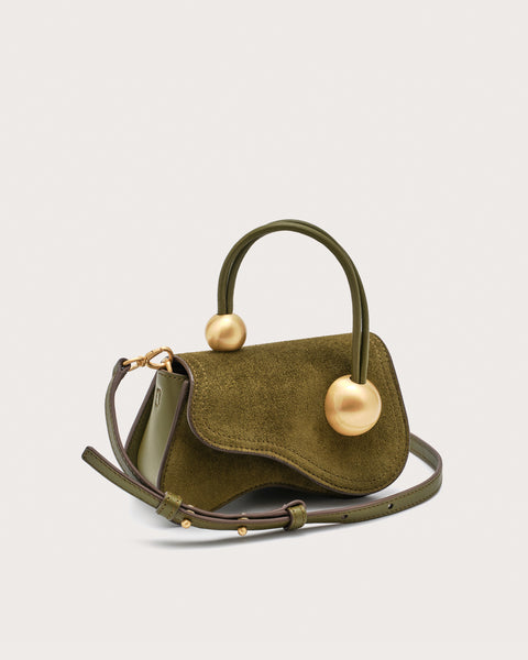 Green handbag with gold accents on a light gray background