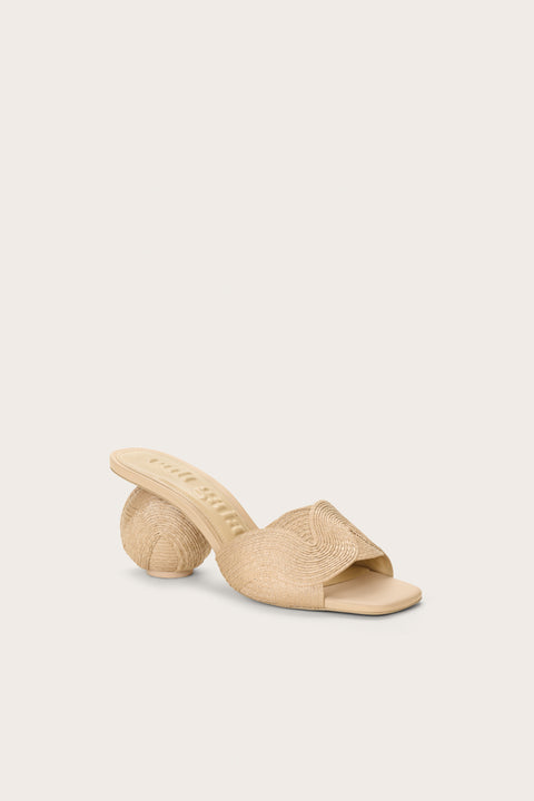 Front angle of a cream jute and leather mule that features a spherical heel and an open toe and back. 