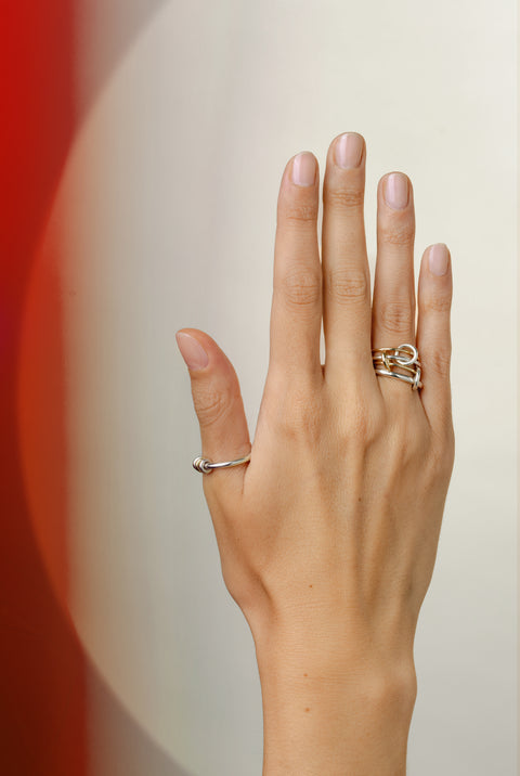 Woman wearing a Spinelli Kilcollin Pisces ring and a Sirius SG ring. 