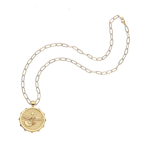 A gold coin pendant that features a flying eagle on a gold chain. 