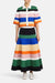 Full body view of a model wearing the multicolor stripe midi skirt with a matching top and facing the camera
