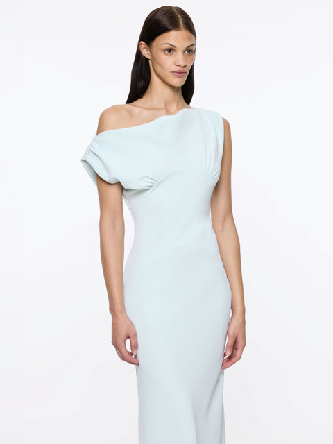 Up close of woman wearing a light blue one-shoulder maxi dress on a white background