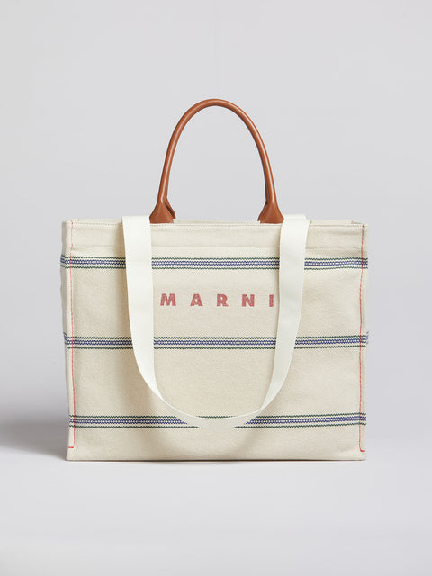Marni medium tote in cream with blue stripes and brown leather straps.