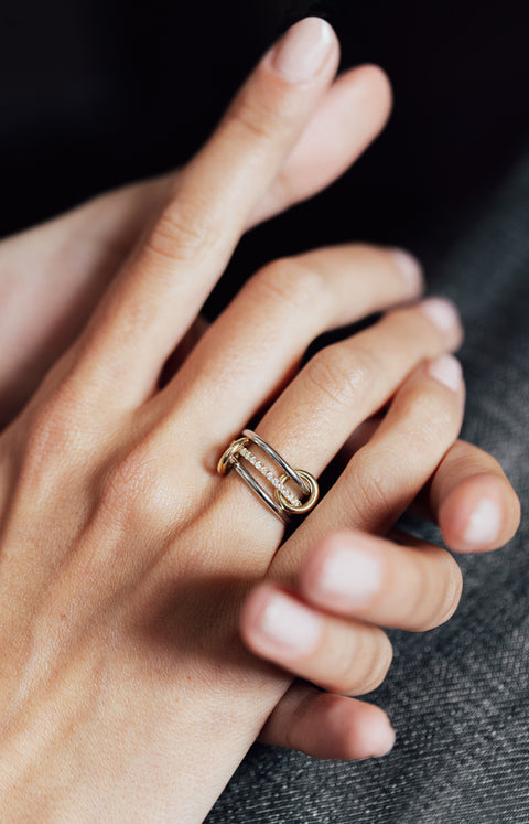 Close up of a woman wearing a Spinelli Kilcollin Sonny SP ring. 
