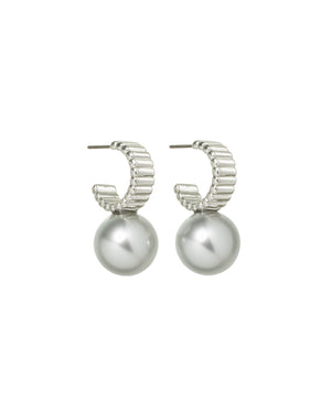 A pair of silver hoop earrings that feature a ribbed design and a polished silver ball below the hoop. 