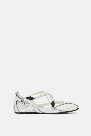 Side profile of a ballerina flat crafted from a textured, white fabric and silver trim, featuring two crisscross top straps and a subtle logo embossed on the heel. 