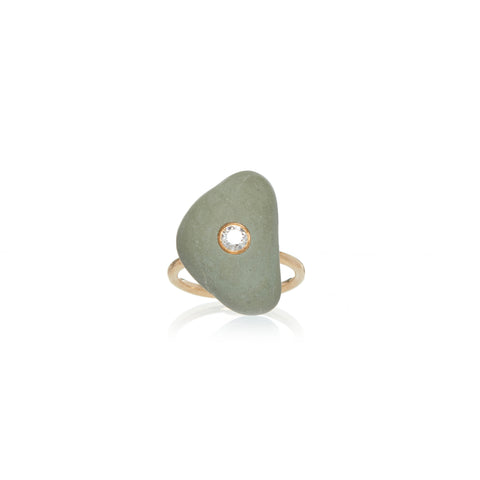 A light green triangular stone embellished with a round diamond in the center, set on a yellow gold ring band. 
