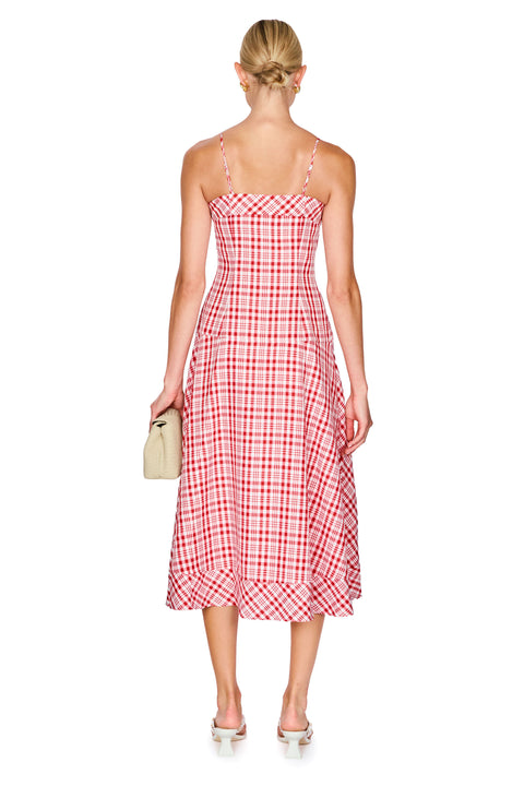 Woman wearing a red and white checkered dress on a white background