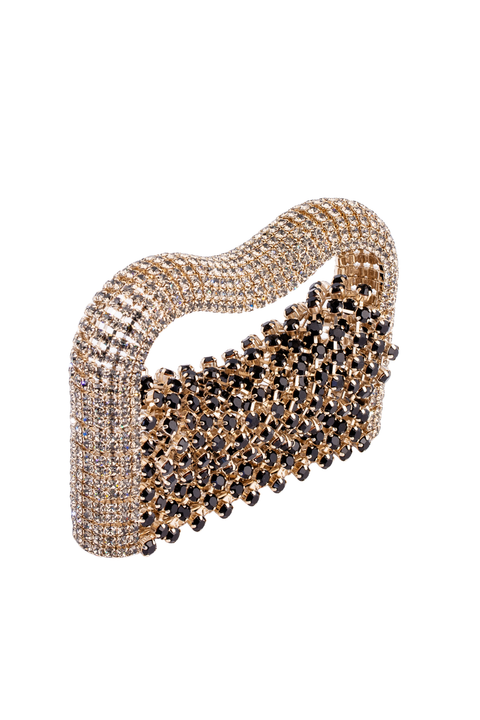 A rhinestone-embellished purse with a wavy, structured silhouette. The clutch features a gold-tone metal base densely covered with clear crystals on the handle and a section of faceted black rhinestones on the body, all set against a plain white background.