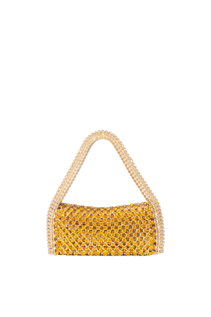 A small structured handbag covered in shimmering gold rhinestones, featuring a single arched handle made of cream rhinestones, set against a plain white background.