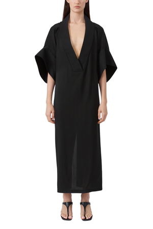 Black dress worn by a model on a white background