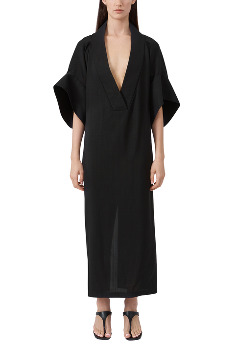 Black dress worn by a model on a white background