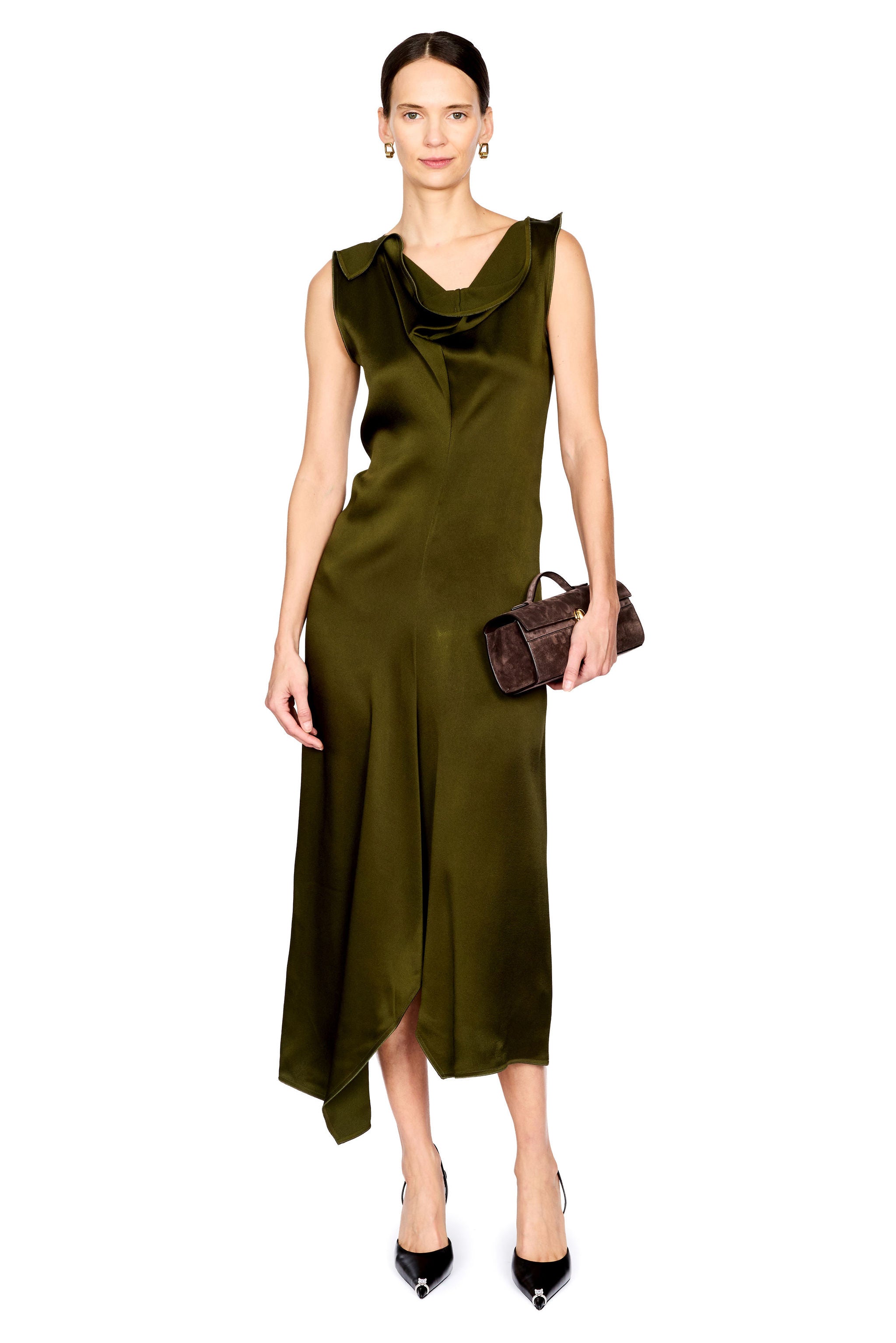 A model wearing a sleeveless olive green satin midi dress with a draped cowl neckline and an asymmetrical hem, holding a small dark brown textured handbag against a solid white background.
