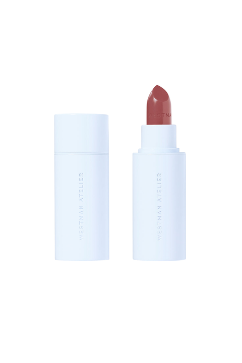 A lipstick bullet shown next to its cap on a clean white background. The lipstick bullet is a muted dusty rose or mauve shade, and the packaging is a matte white with vertical branding text.