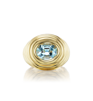 Gold ring with a blue gemstone on a white background