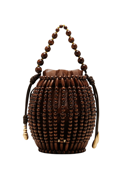 A dark brown wooden bucket bag decorated with vertical rows of round wooden beads, featuring a matching beaded top handle and drawstring ties with gold-toned accents, shown against a plain white background.