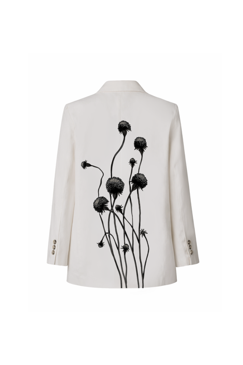 An off-white tailored blazer shown from the back, featuring a prominent black graphic print of thistle-like flowers on the back panel.