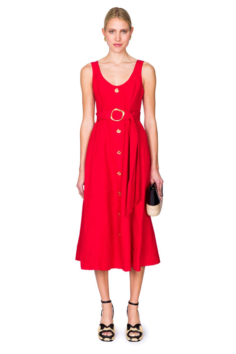 Woman wearing a red dress with a gold embellished belt on a white background