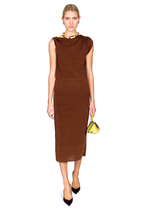 Woman wearing a brown dress holding a yellow handbag on a white background