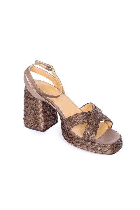 Top view of brown woven sandal with a platform sole on a white background