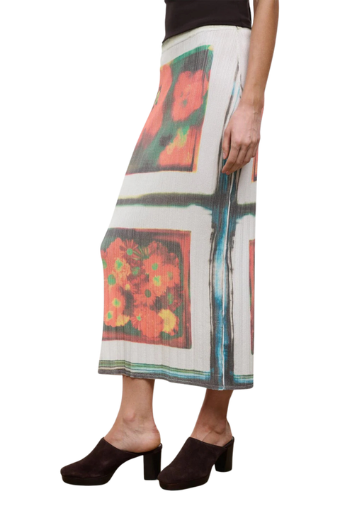 Woman wearing a floral patterned midi skirt set on a white background close up