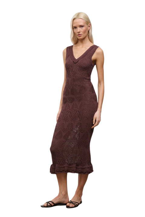 Woman wearing a brown lace dress on a white background side angle