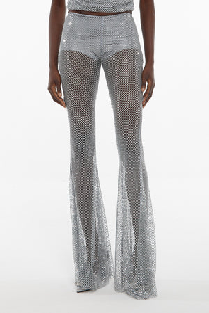 Up close of model wearing Giuseppe rhinestone embroidered mesh flare pants in silver