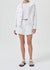 Full body view of the white denim short on a model