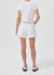 Model facing the back in the white denim short