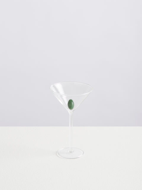 Maison Balzac martini glass with green glass olive inside.
