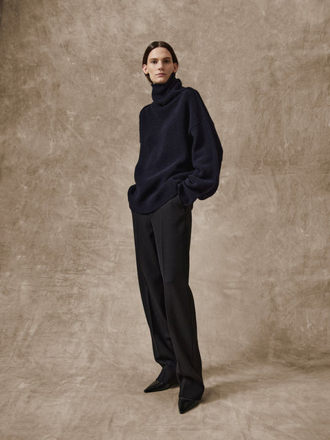 Model wearing Rohe cigarette leg trousers in black